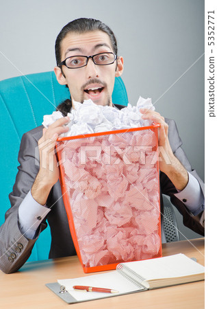 Man with lots of wasted paper 5352771