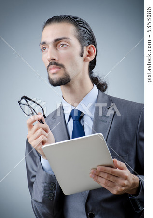 Businessman working on tablet computer Businessman working on tablet computer 5353086