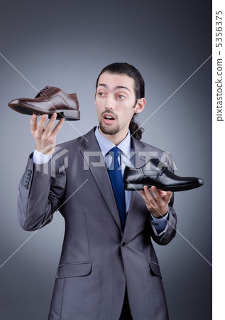 Man with a selection of shoes Man with a selection of shoes 5356375