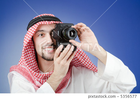 Arab photographer in studio shooting 5356577