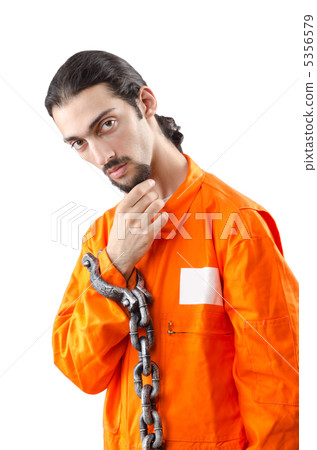Criminal in orange robe in prison 5356579
