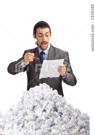 Man with lots of waste paper 5356588
