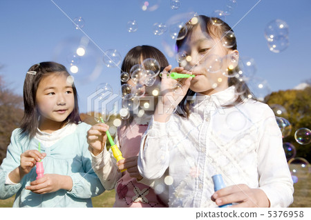Girls playing bubbles Girls playing bubbles 5376958