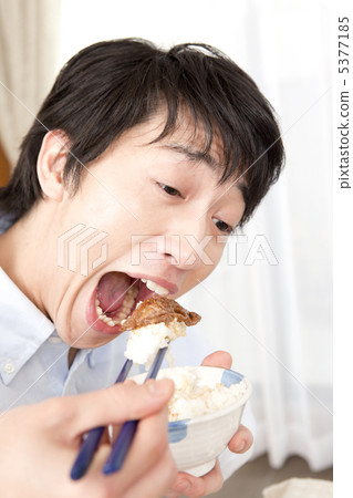 A man eating grilled meat 5377185