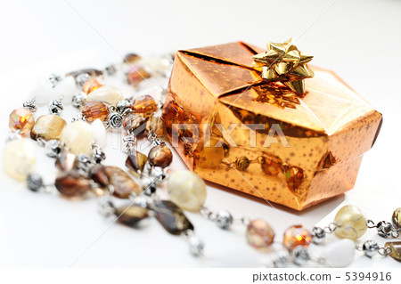 Golden gift box with decoration on white background Golden gift box with decoration on white background 5394916