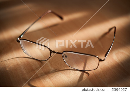 Eyeglasses on warm background Eyeglasses on warm background 5394957