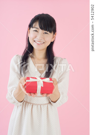 A woman giving a gift 5412902