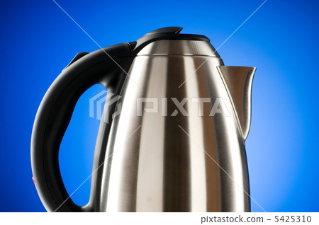 Shiny kettle against the colorful gradient background 5425310