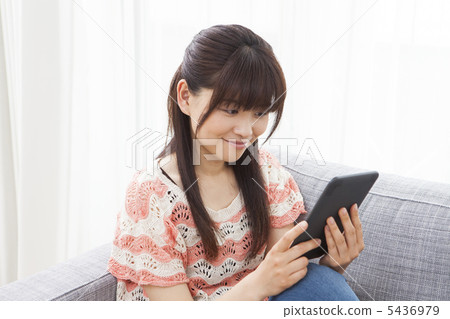 A woman reading an e-book A woman reading an e-book 5436979
