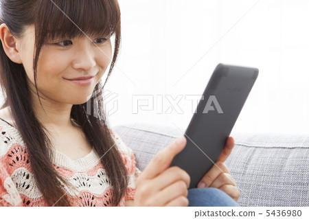 A woman reading an e-book A woman reading an e-book 5436980