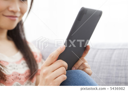 A woman reading an e-book A woman reading an e-book 5436982