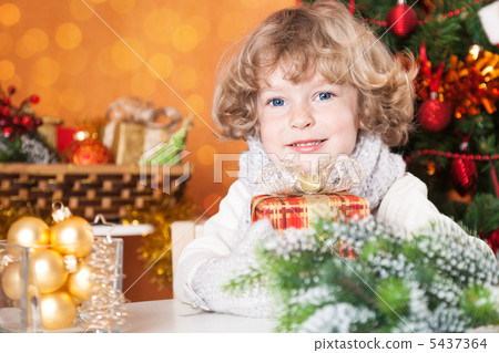 Happy child holding present 5437364