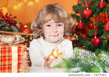 Happy child holding gold balls Happy child holding gold balls 5437365