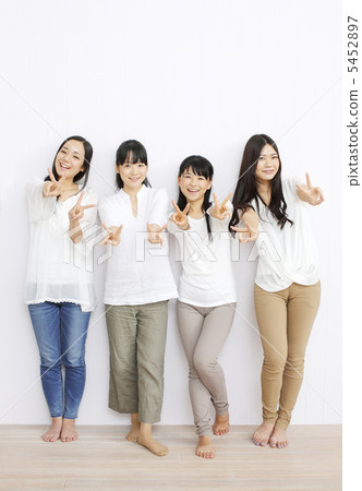 Four girls standing with a smile Four girls standing with a smile 5452897