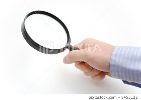 Businessman looking through the loupe 5453122