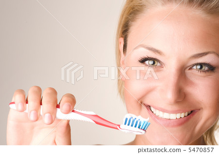 Happy Young Woman Brushing Her Teeth 5470857