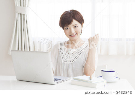 A woman heading to a computer at home 5482848
