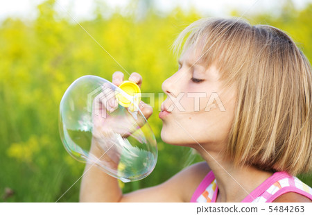 Little Girl Blowing Soap Bubbles Little Girl Blowing Soap Bubbles 5484263