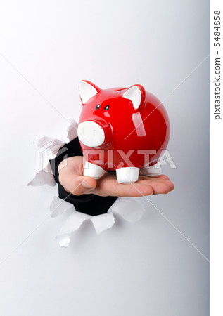 Hand holding through the hole in paper 5484858