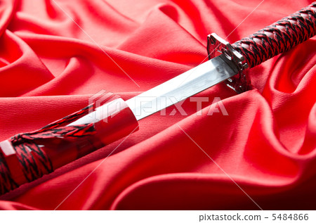 Japanese sword takana on red satin background Japanese sword takana on red satin background 5484866