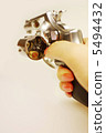 Woman's hand holding a gun 5494432