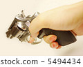 Woman's hand holding a gun 5494434