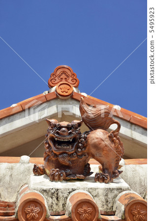 Shisa on the red tile roof and the blue sky Shisa on the red tile roof and the blue sky 5495923