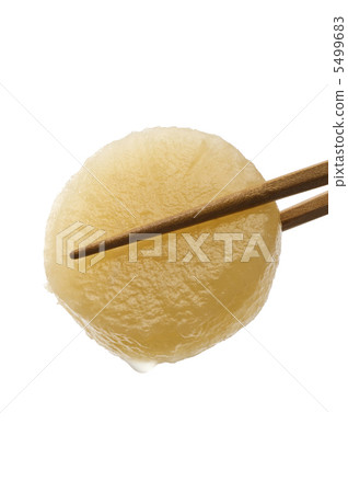Daikon radish grabbed with chopsticks 5499683