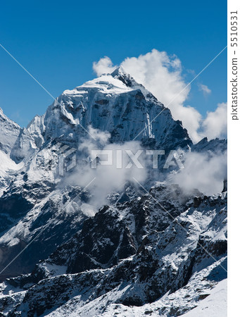 Taboche mountain peak and clouds viewed from Renjo pass 5510531