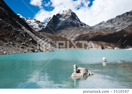 Balance: Pebble stacks and Sacred Lake near Gokyo Balance: Pebble stacks and Sacred Lake near Gokyo 5510597