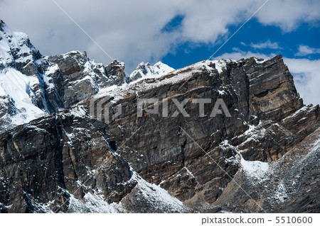 From the top of Gokyo Ri: rocks and snowed cliffs view 5510600