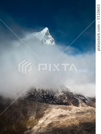 Cholatse 6335 m peak hidden in clouds 5510603