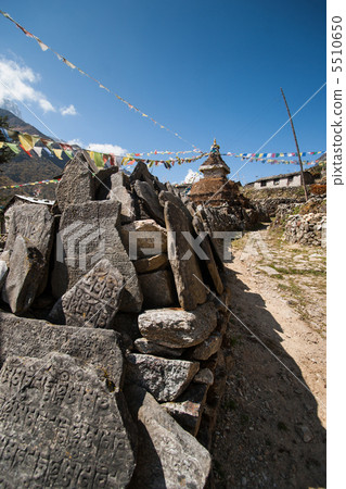 Mani stones and Buddhist stupe or chorten in Himalayas 5510650