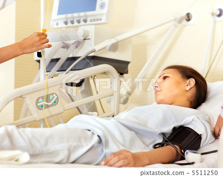 Woman on gurney in operating room. Woman on gurney in operating room. 5511250