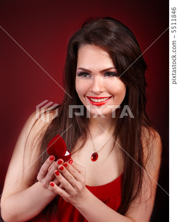 Girl with jewellery box on red background. Girl with jewellery box on red background. 5511846