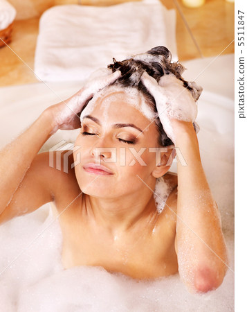 Woman washing hair by shampoo . 5511847