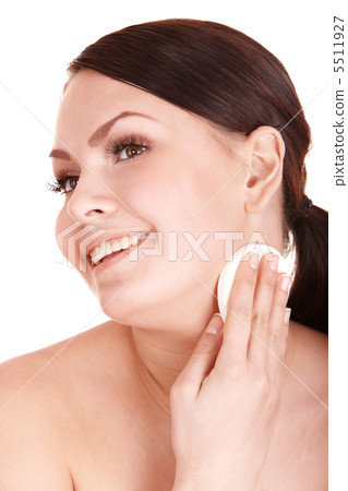 Young woman washing her face by sponge. 5511927