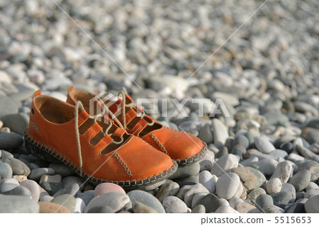 sandals on a pebbled beach sandals on a pebbled beach 5515653