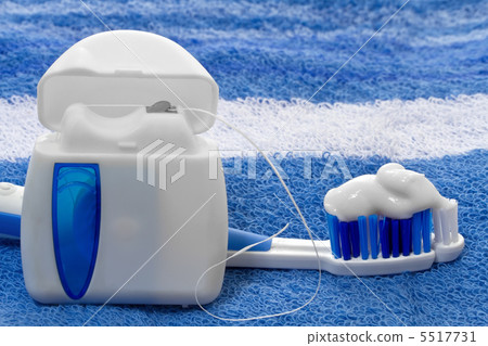 dental floss and toothbrush on a towel 5517731