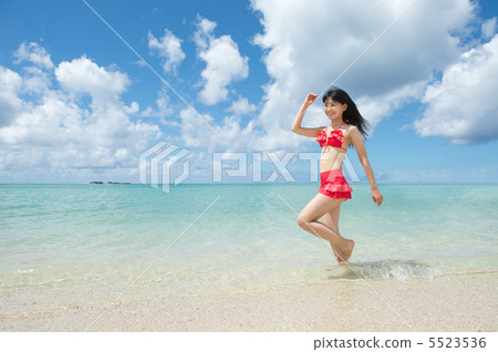 Women in swimwear walking on the beach Women in swimwear walking on the beach 5523536