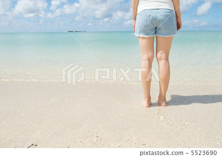 A woman standing on the beach A woman standing on the beach 5523690