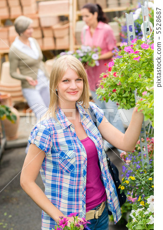 Woman at garden centre shopping for flowers 5528687