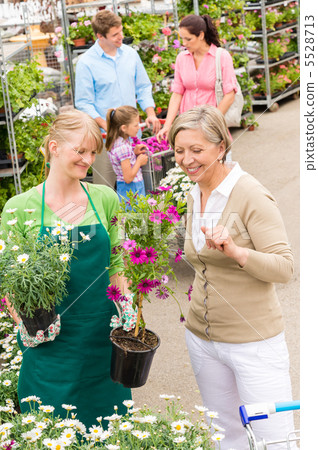Customer at garden centre buying potted flowers 5528713