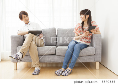 A couple looking at a tablet A couple looking at a tablet 5529335