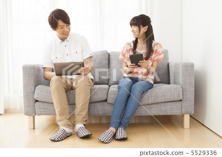A couple looking at a tablet A couple looking at a tablet 5529336