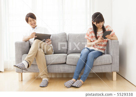 A couple looking at a tablet A couple looking at a tablet 5529338