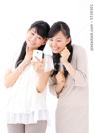 Two girls watching smartphones Two girls watching smartphones 5530301