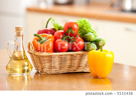Healthy food fresh vegetables in basket and bottle with oil on t 5531436