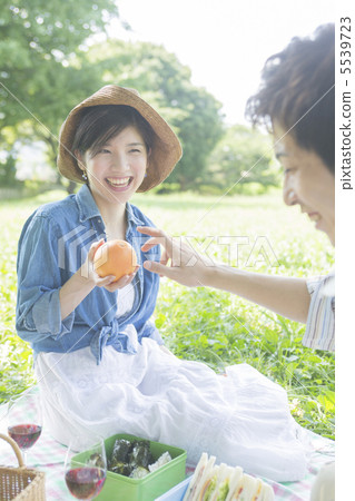 Smiling woman with orange 5539723