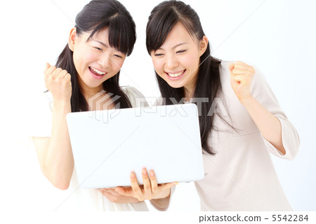 Two girls using a laptop computer 5542284